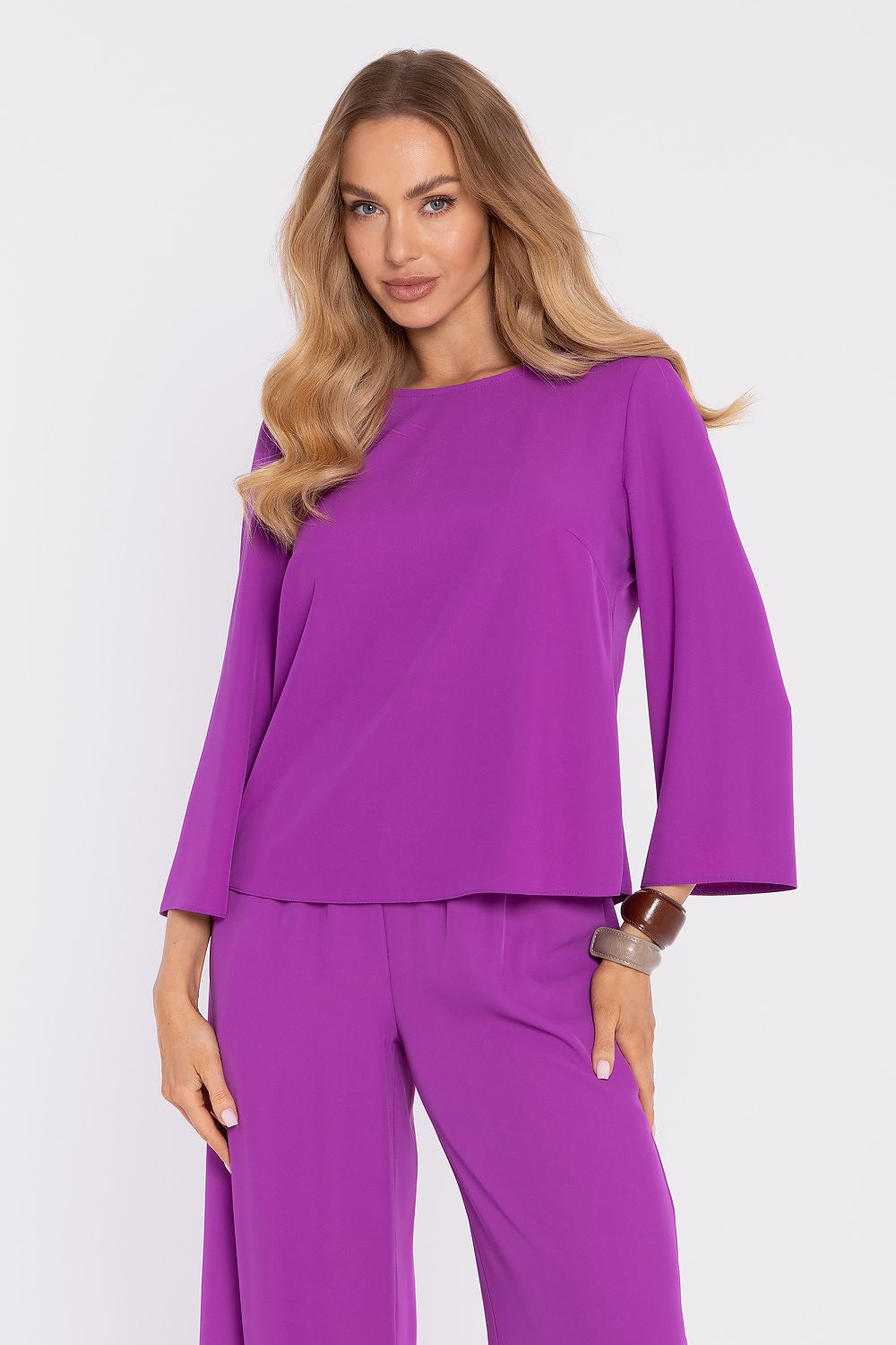 Violet blouse with round neckline and flared sleeves; matching wide-leg pants.