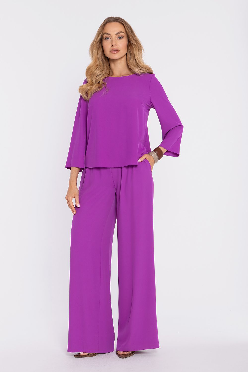 Violet blouse with elbow-length flared sleeves and round neck; matching wide-leg pants.