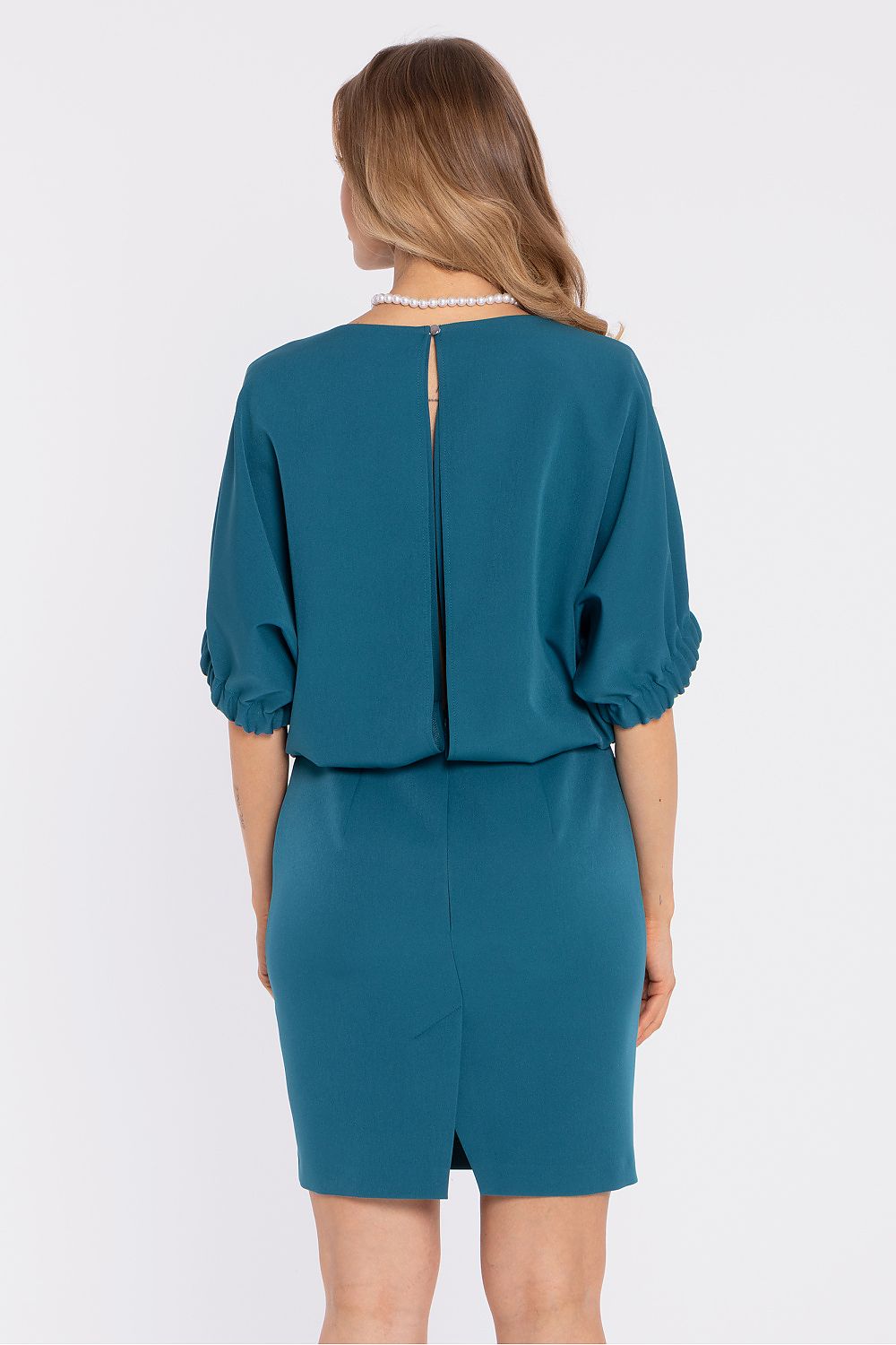 Teal daydress back view with center seam opening and knee-length straight skirt.