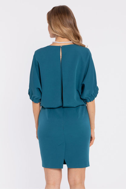 Teal daydress back view with center seam opening and knee-length straight skirt.