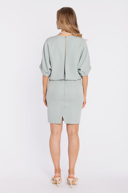Sage daydress back view with center seam opening and knee-length straight skirt.