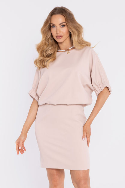 Light blush pink daydress with short puff sleeves, round neckline, and fitted skirt.