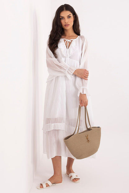White tiered daydress with lace-up neckline and long puff sleeves