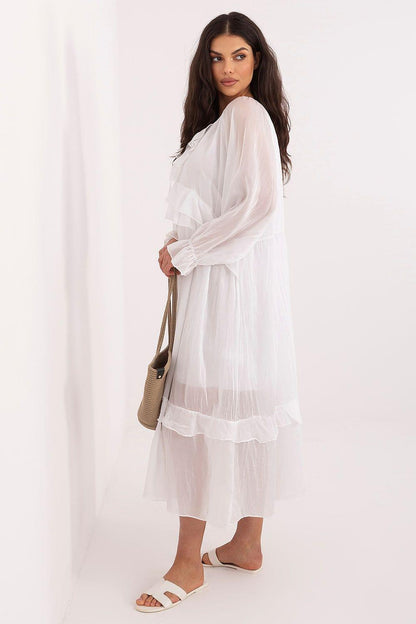 White tiered daydress with long sleeves and ruffled hem