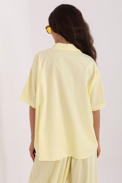 Short-sleeve button-up shirt in pale yellow, back view with yoke and loose fit