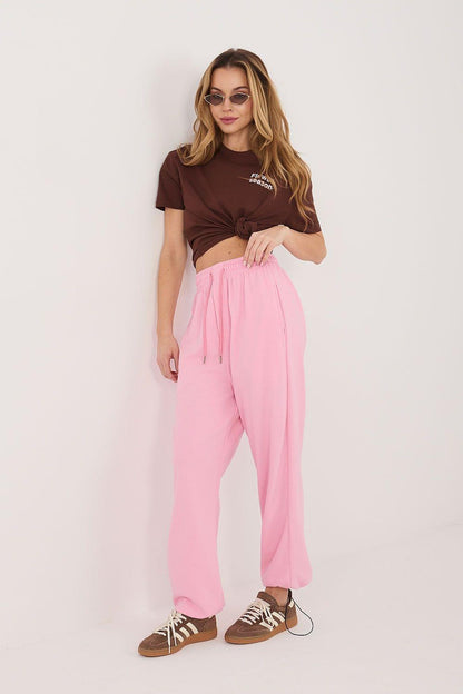Pink track trousers with drawstring waist and relaxed straight legs