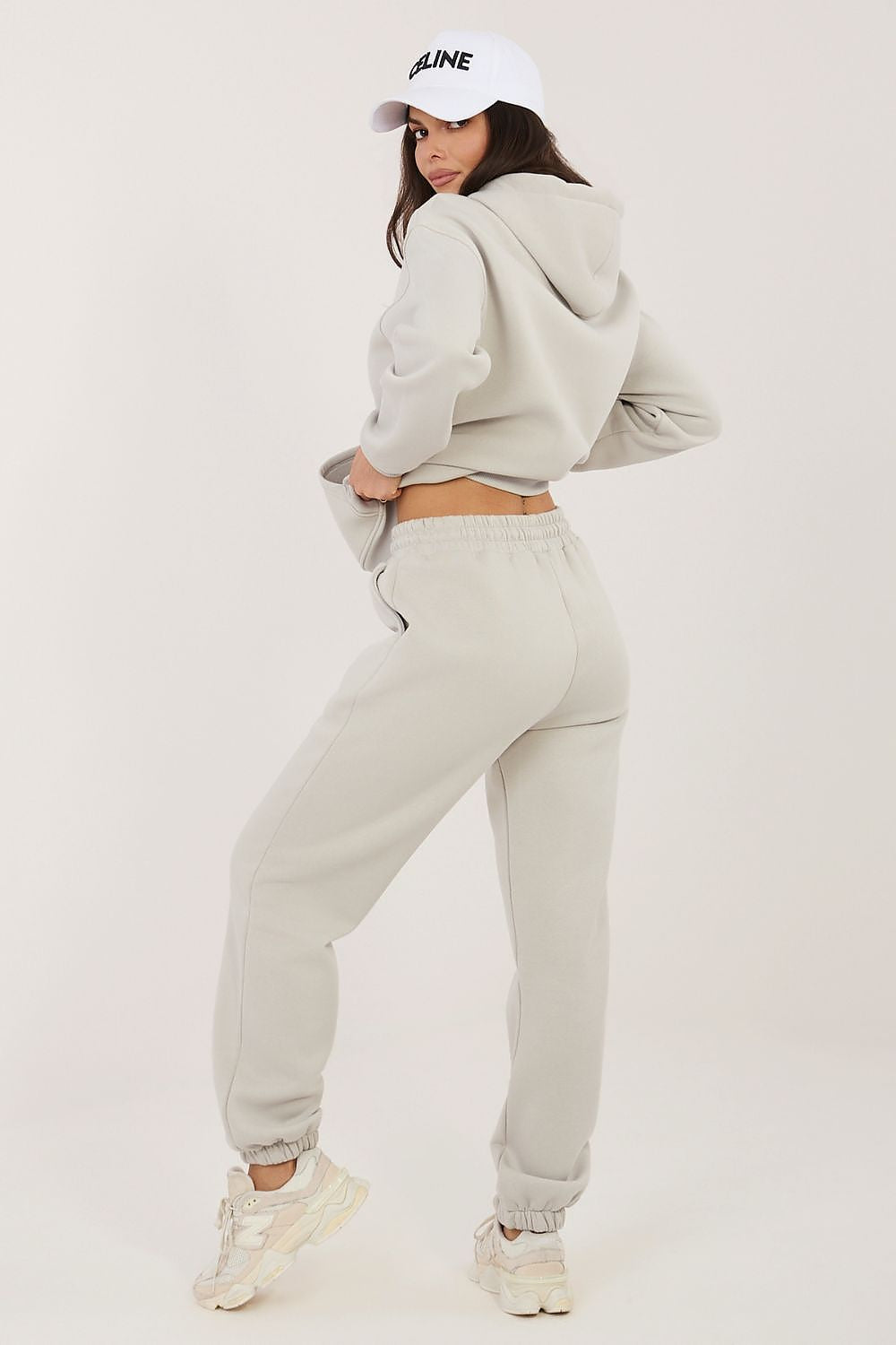 Light beige hoodie and jogger set viewed from back with drawstring hood