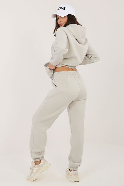 Light beige hoodie and jogger set viewed from back with drawstring hood