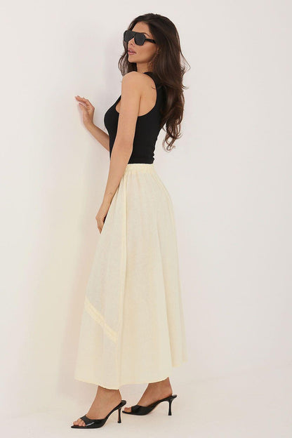 Cream long skirt with gathered waist and tassel drawstring ties, side view