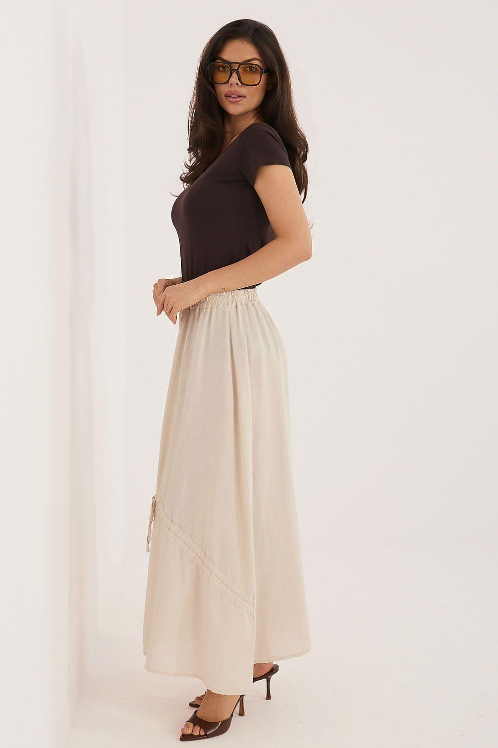 Cream long skirt with gathered waist and tassel drawstring side ties, front view