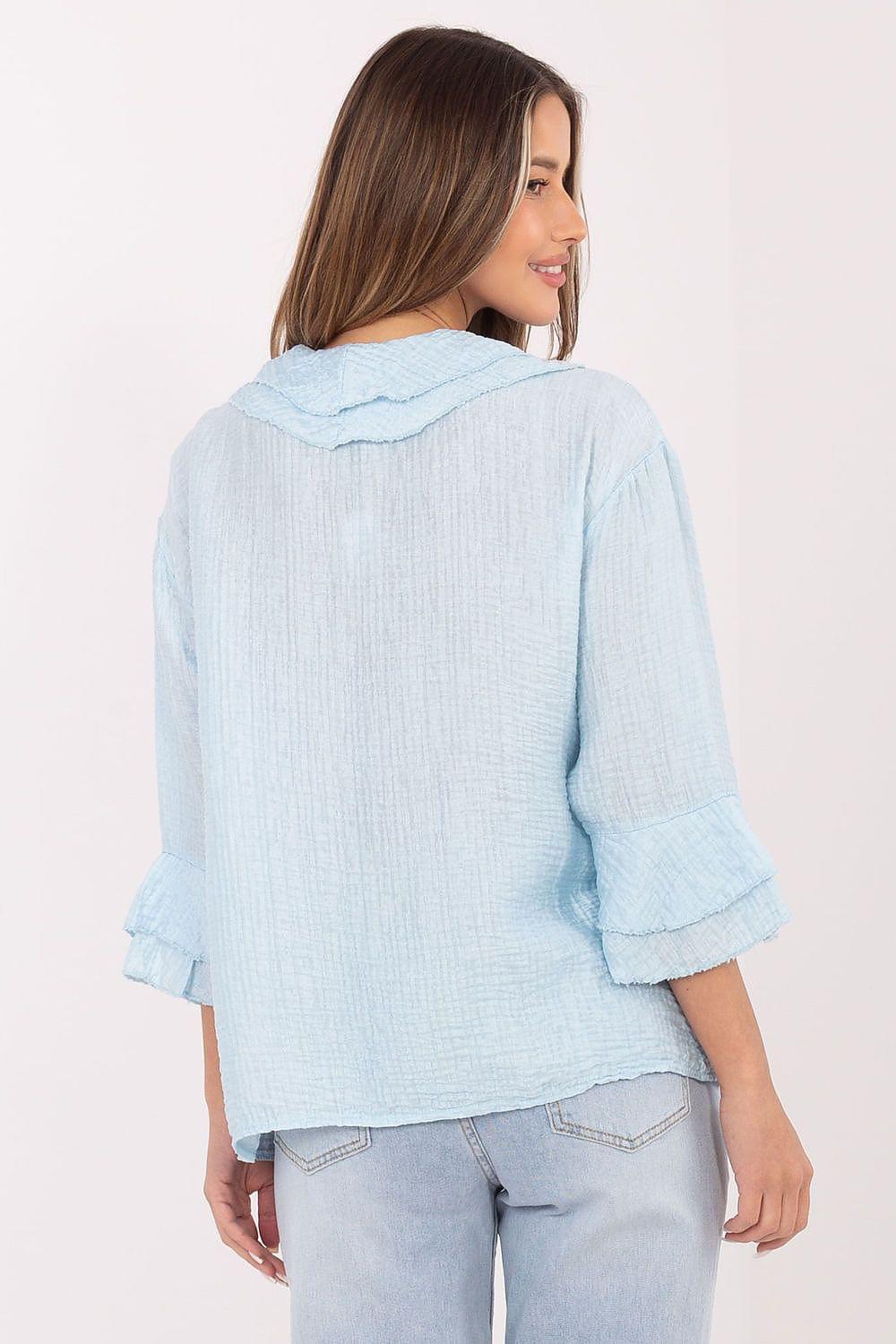 Light blue long-sleeve shirt, back view with buttoned yoke and flared cuffs