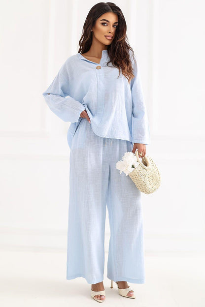Women’s light blue wide-leg trousers with stitched hems and front closure