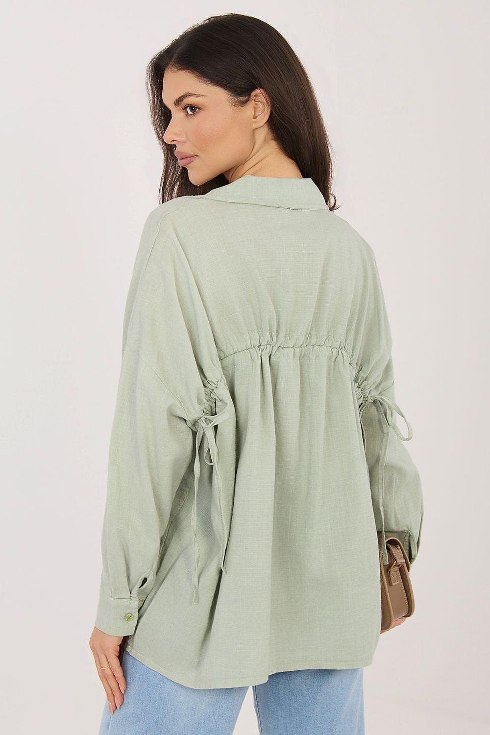 Sage green long sleeve shirt, back view with gathered yoke and tie at waist