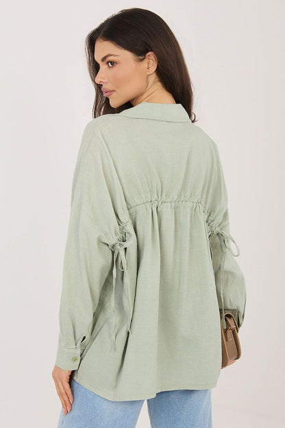 Sage green long sleeve shirt, back view with gathered yoke and tie at waist