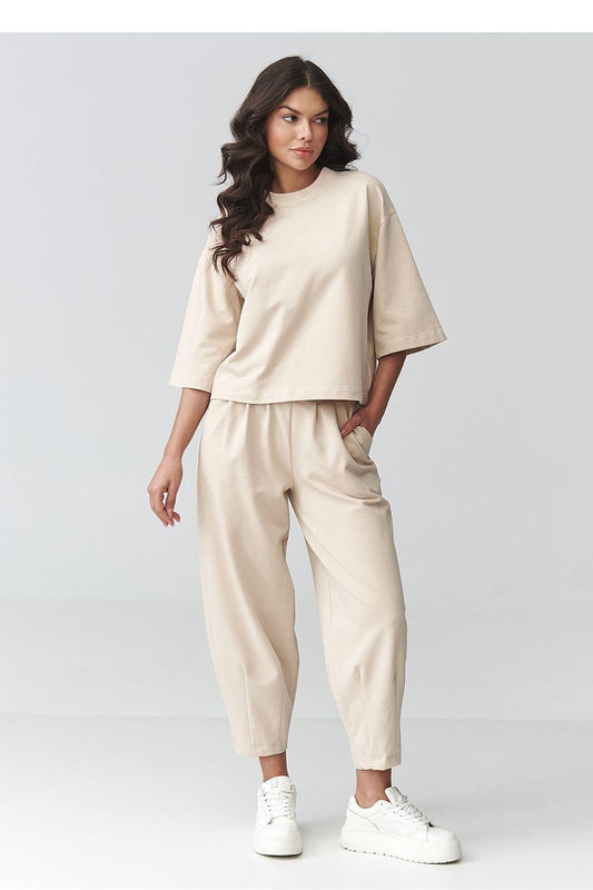 Beige two-piece set with short-sleeve top and tapered cropped pants