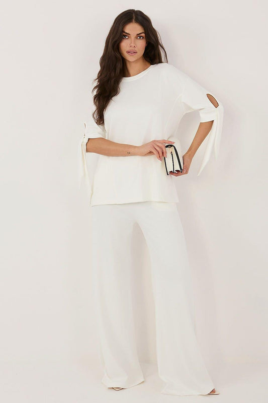 White two-piece set with short-sleeve top and wide-leg pants, side tie detail