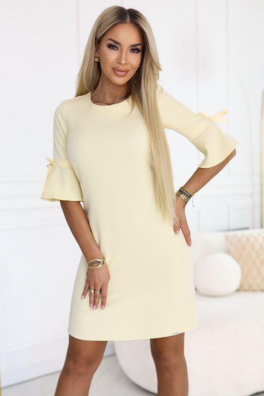 Pale yellow daydress with short flared sleeves and straight above-knee hem