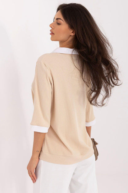 Beige knit polo blouse, back view with ribbed texture and white cuffs