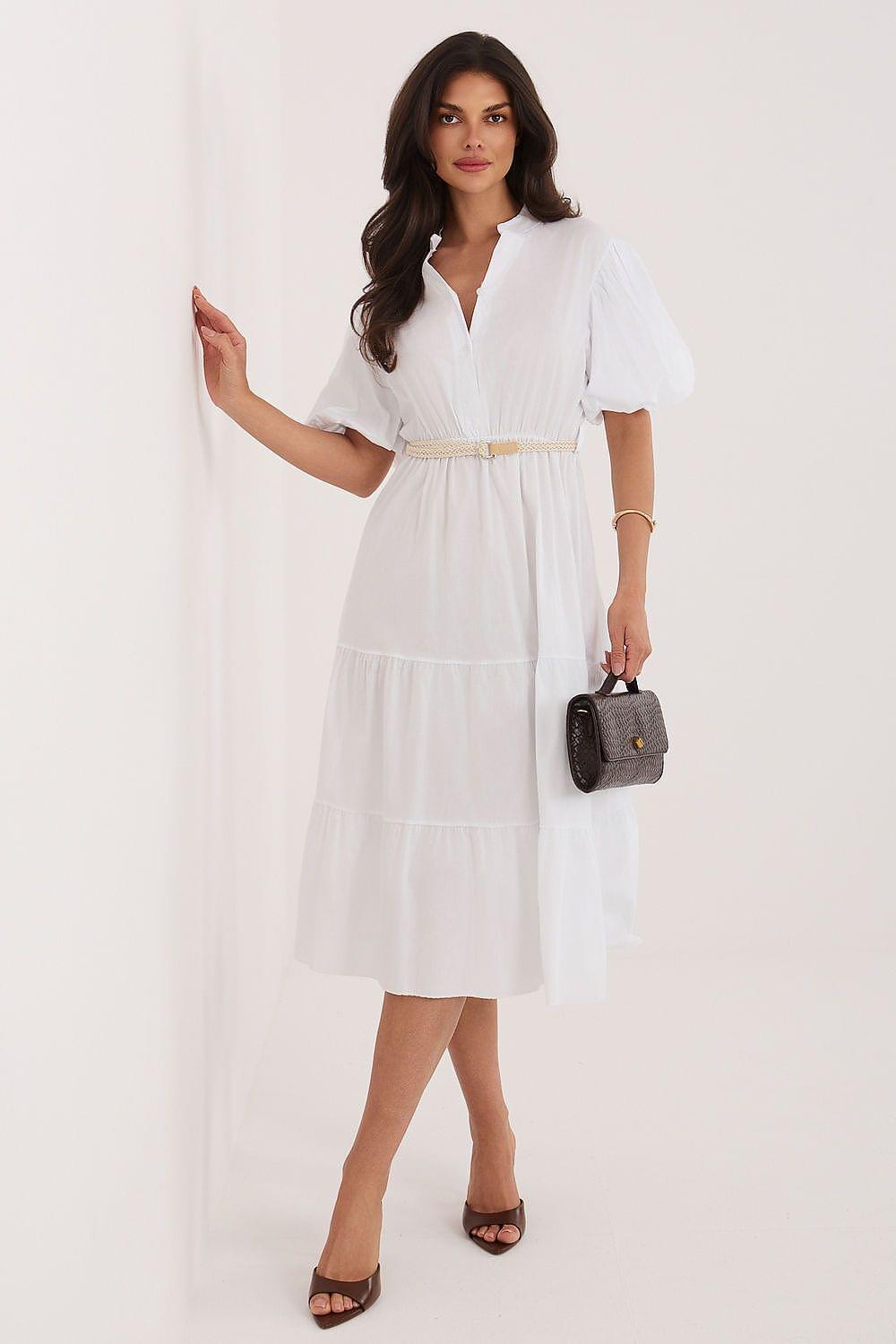 White tiered daydress with V-neck and short puff sleeves, belted waist.