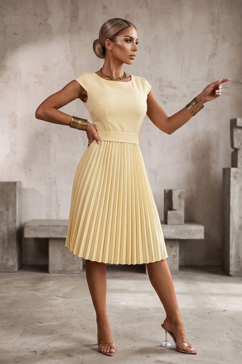 Pale yellow sleeveless daydress with pleated skirt and fitted waist