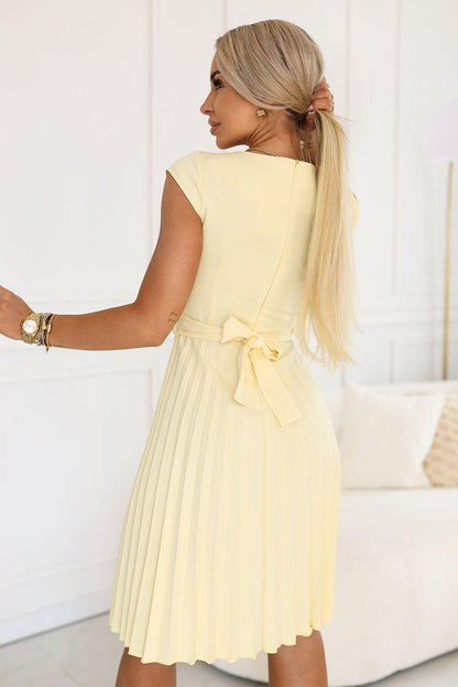Pale yellow daydress with pleated skirt and back ribbon bow