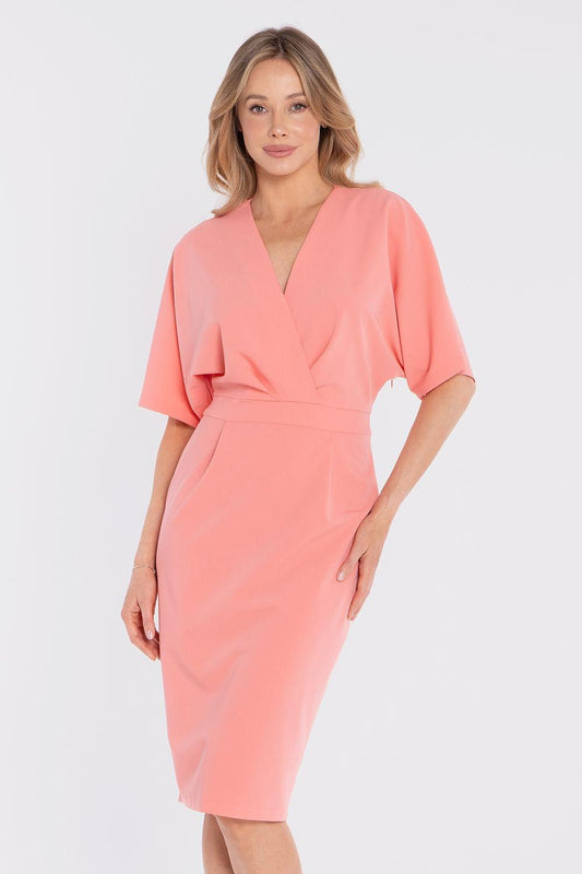 Pink day dress with V-neck wrap front, short sleeves, and tied waist seam detail.