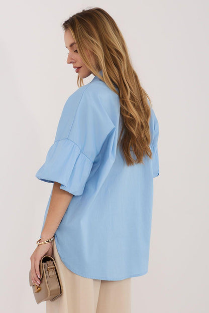 Light blue button-front shirt with pointed collar and short puff sleeves, angled view