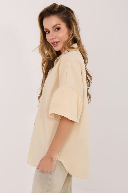 Cream button-front shirt with pointed collar and short puff sleeves, side view