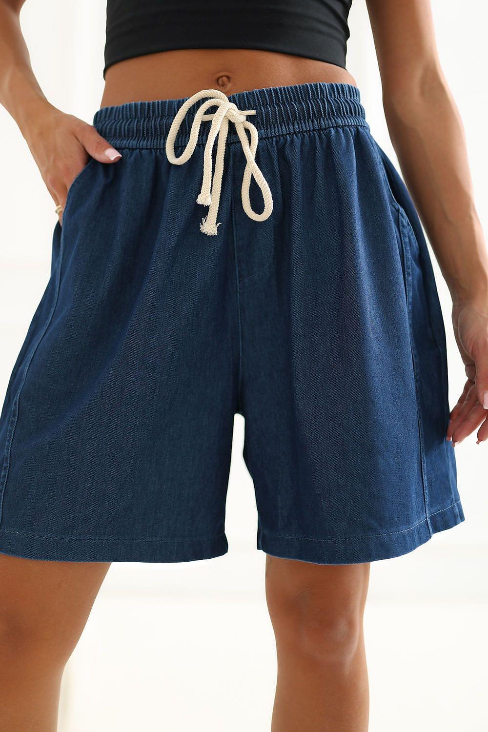 Blue denim-style shorts with elastic waistband, white drawstring tie, pockets