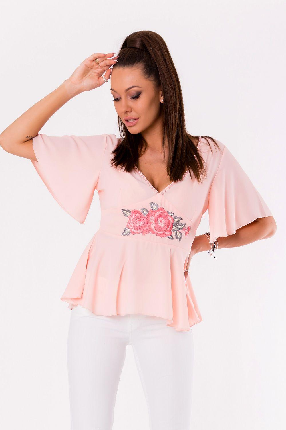 Pink blouse with deep V neckline, rose embroidery, and flared peplum hem detail