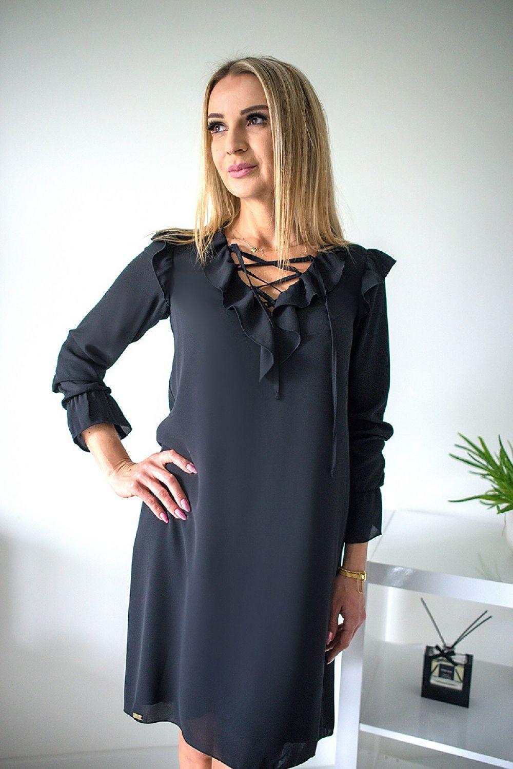 Black evening dress with long sleeves, ruffled shoulders, and crisscross V neckline.