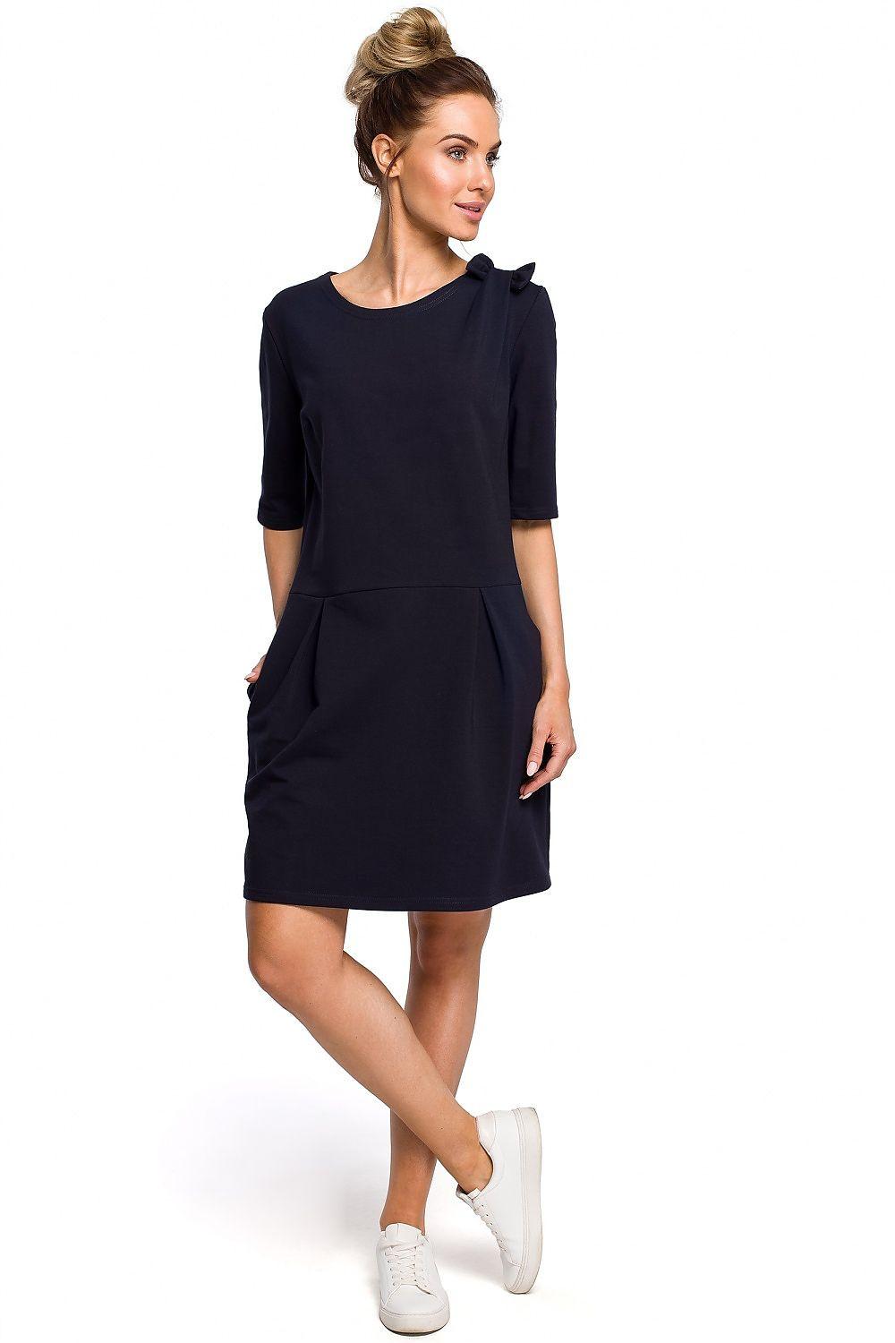 Navy blue day dress with round neckline, short sleeves, and side pockets