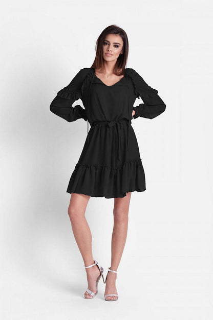 Black cocktail dress with tie waist, long puff sleeves, and tiered ruffle skirt