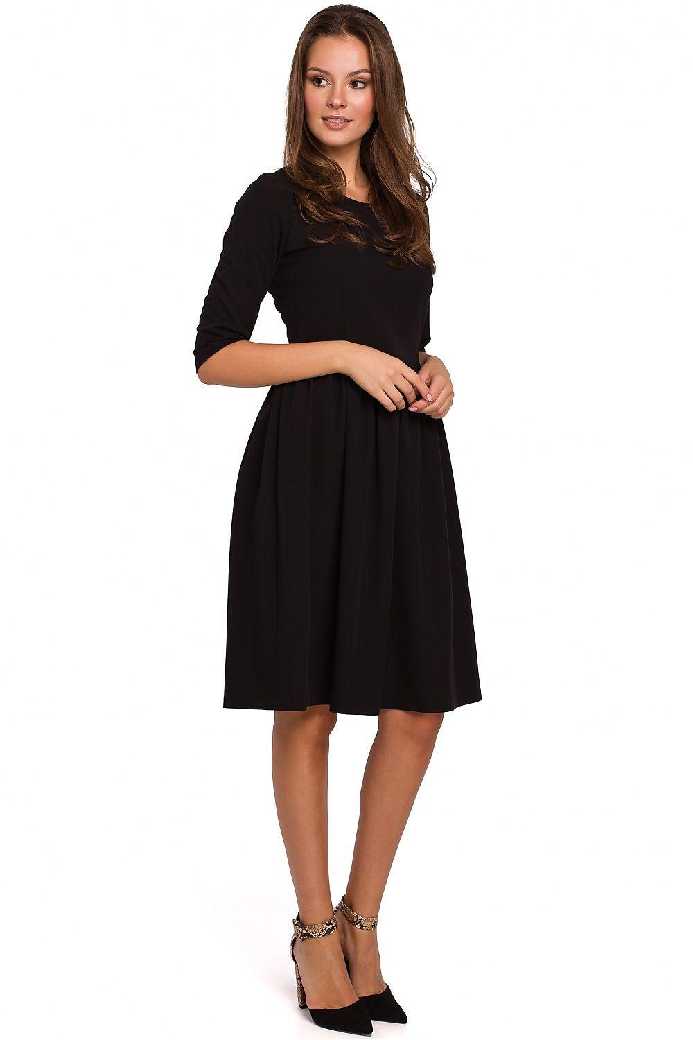 Black daydress with 3/4 sleeves and gathered waist, knee-length flared skirt