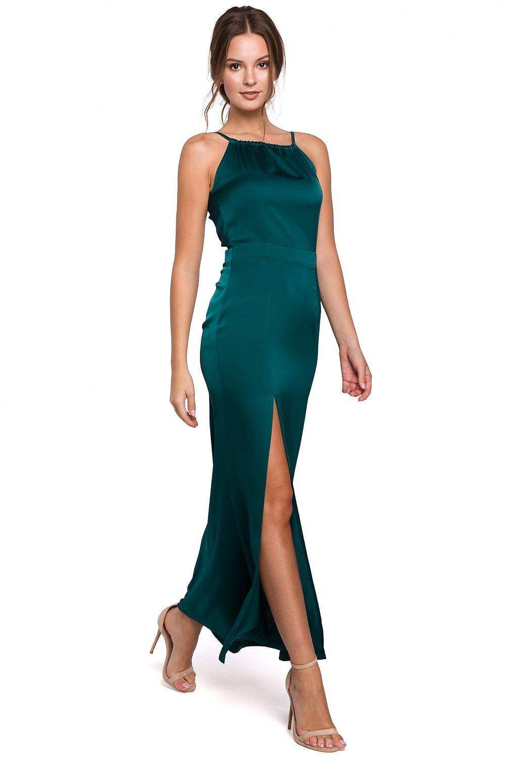 Long green dress with halter neckline, fitted waist, and side slit hem