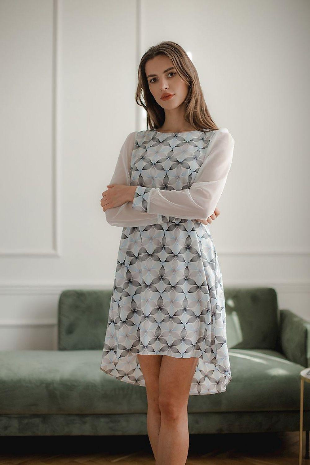 Geometric patterned cocktail dress with sheer long sleeves and uneven ruffled hem