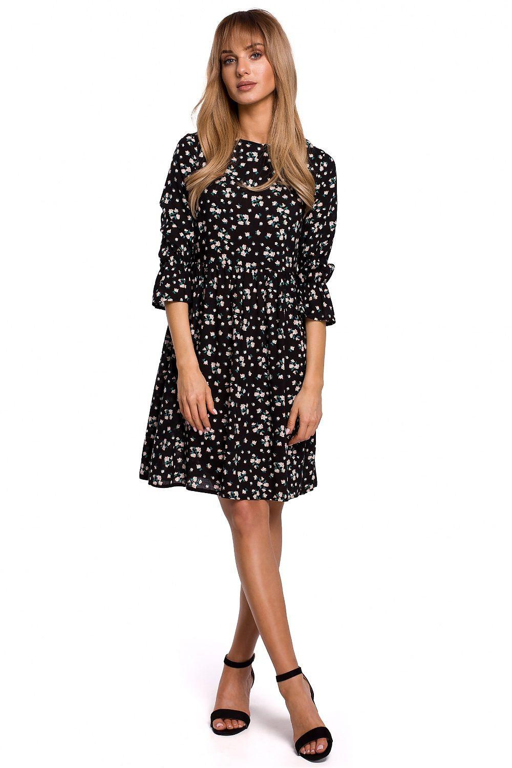 Black above-knee daydress with white floral sprig print, long sleeves, gathered waist