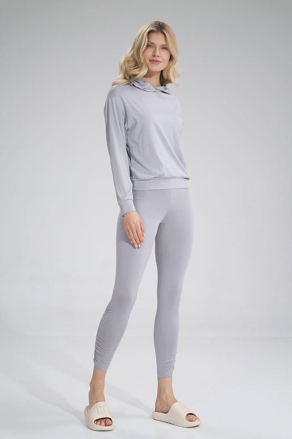 Grey long leggings with wide waistband and gathered creases at the leg.