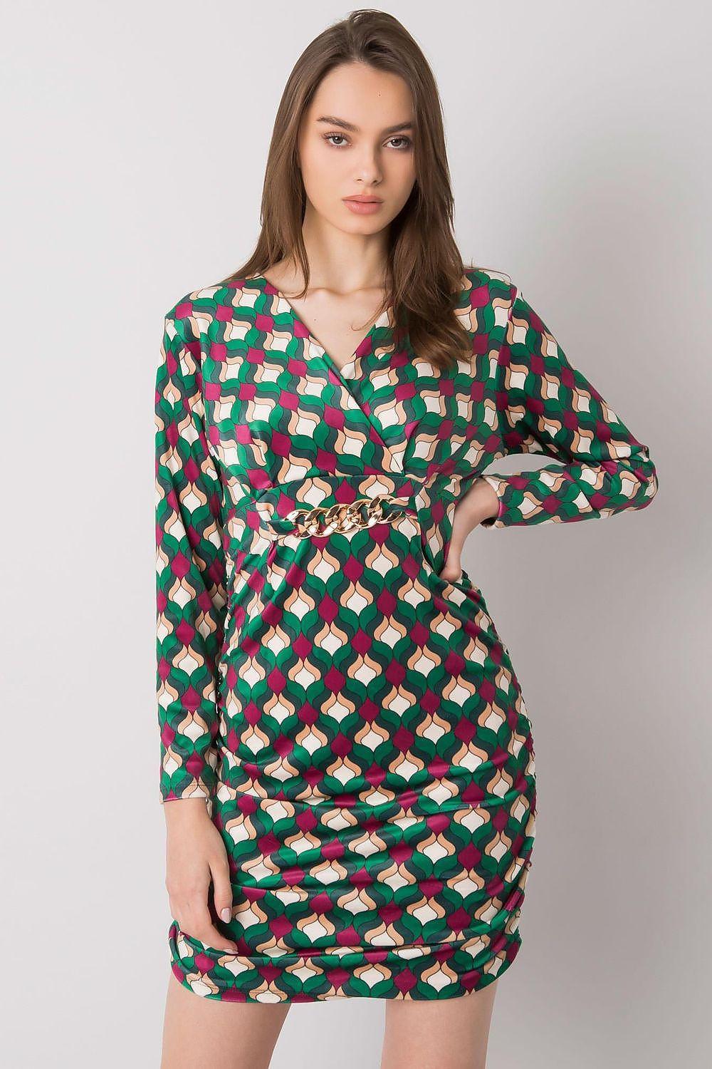 Green patterned daydress with long sleeves, V-neck, and tie waist detail.
