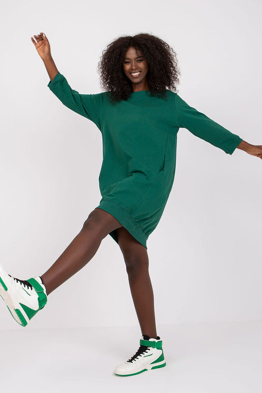 Green loose-fit cotton daydress with long sleeves and side pockets, knee-grazing hem