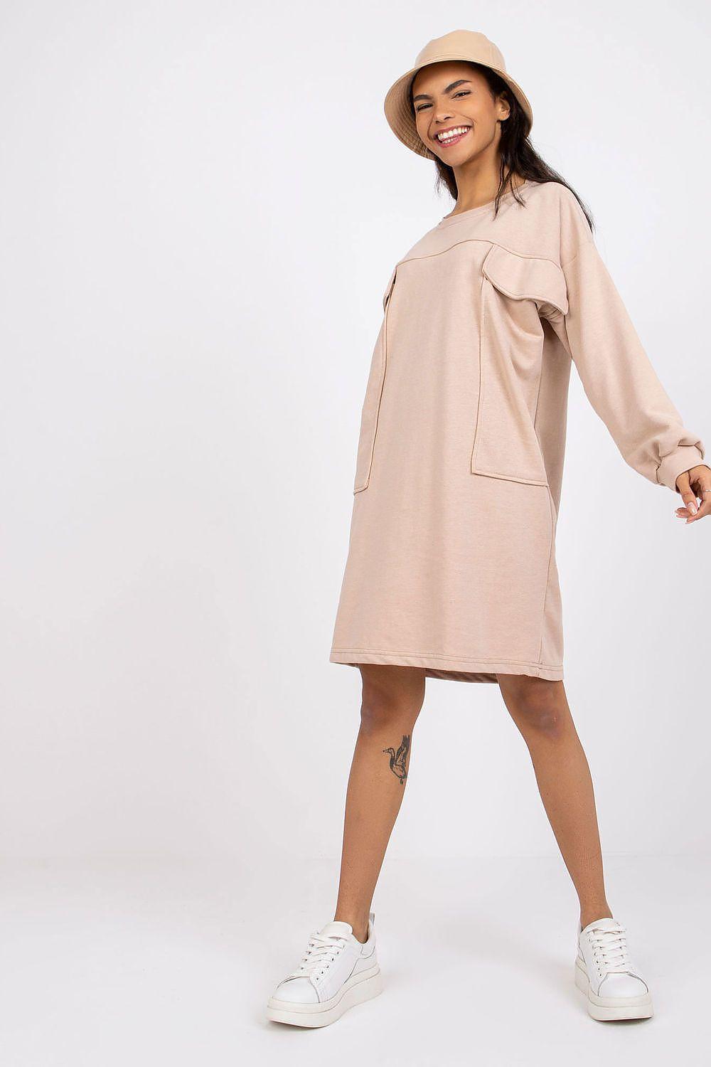 Beige long-sleeve daydress with crew neck and front flap pocket, loose fit.
