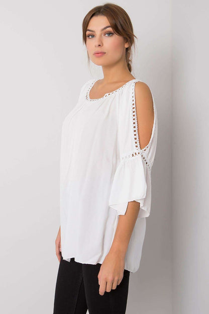 White blouse with lace-trimmed cutout shoulder and elbow-length sleeves