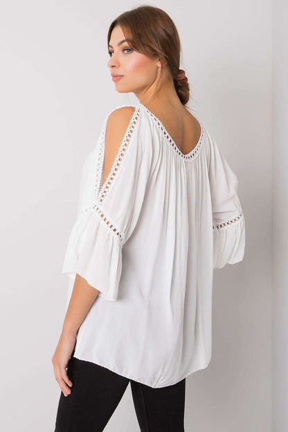 White cold-shoulder blouse with embroidered eyelet trim and flared three-quarter sleeves