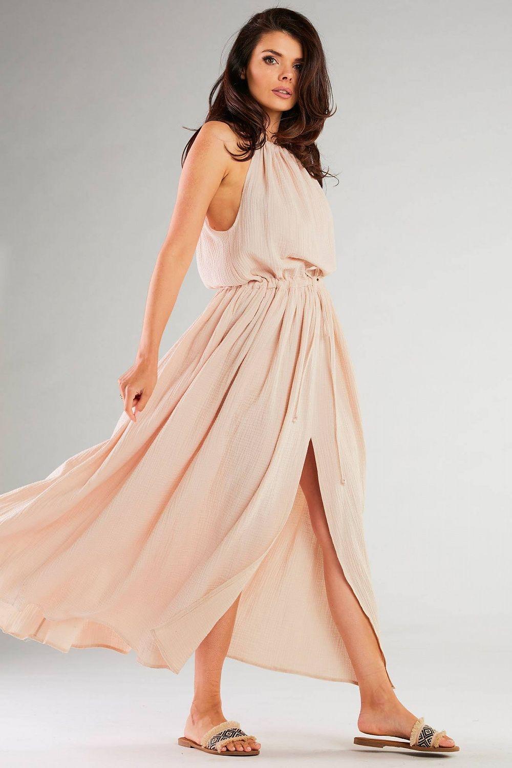 Beige daydress with halter neckline, tie front, gathered waist and flowy maxi skirt.
