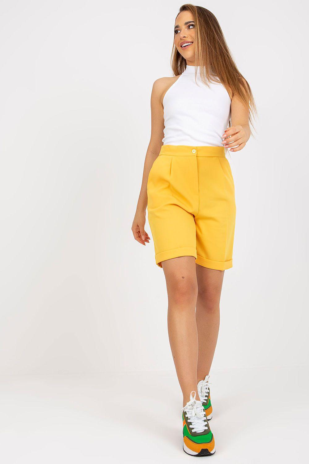 High-waisted yellow shorts with turned-up hem