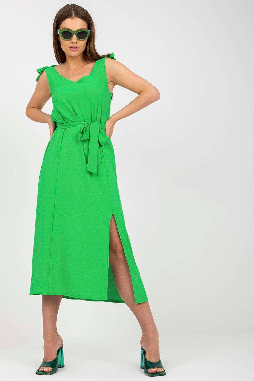 Green sleeveless daydress with V neckline, tie waist, and side slit