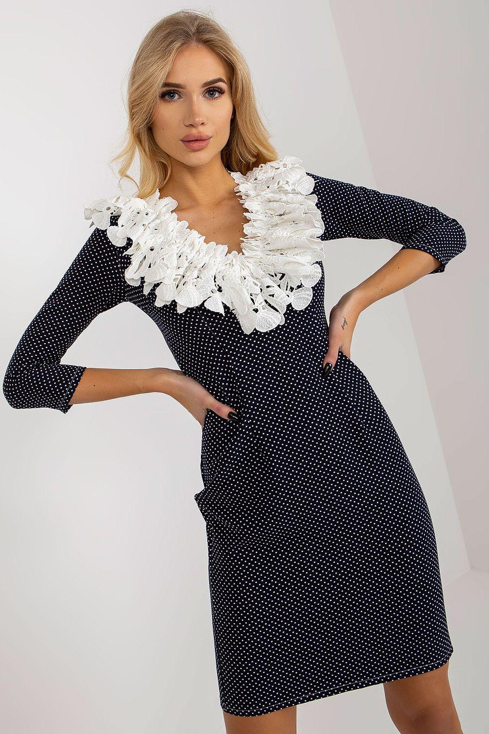 Navy blue polka dot cocktail dress with white ruffled lace neckline and long sleeves