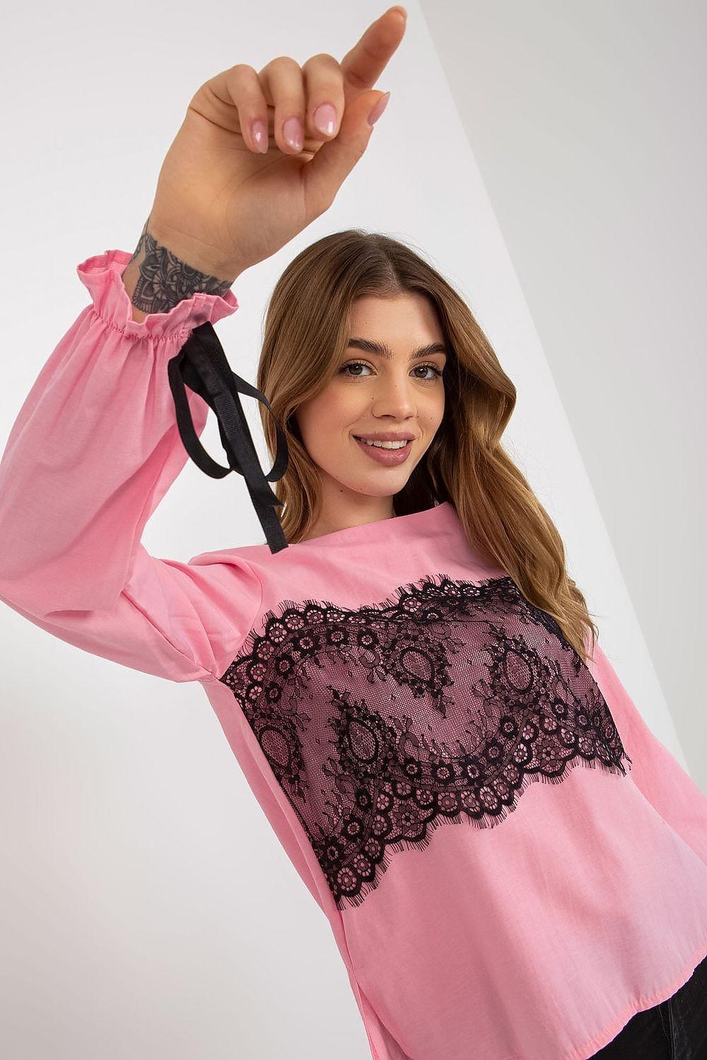 Pink blouse with dark lace yoke and tie cuffs, long sleeves.