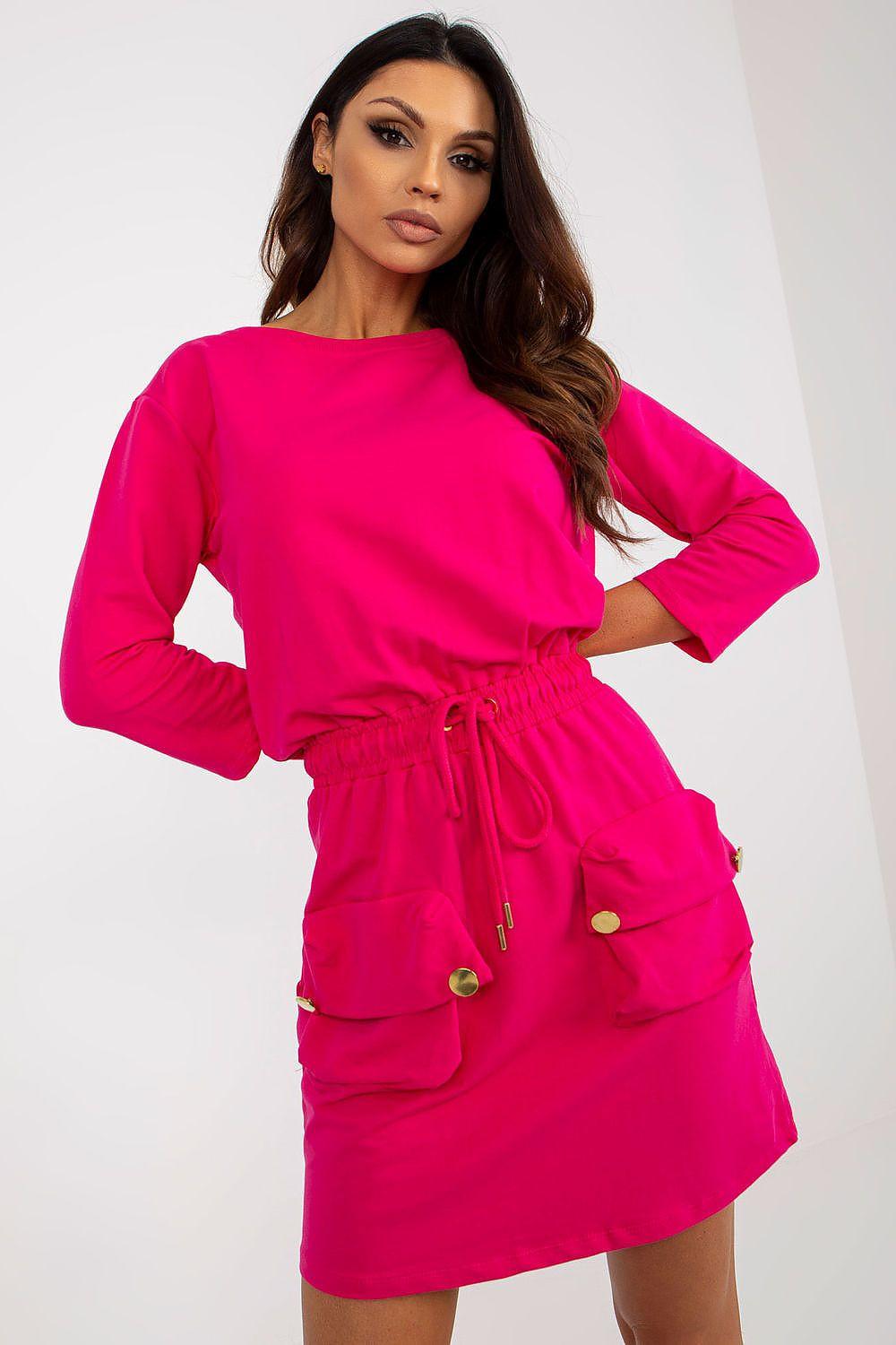 Pink daydress with long sleeves, drawstring waist and two front patch pockets