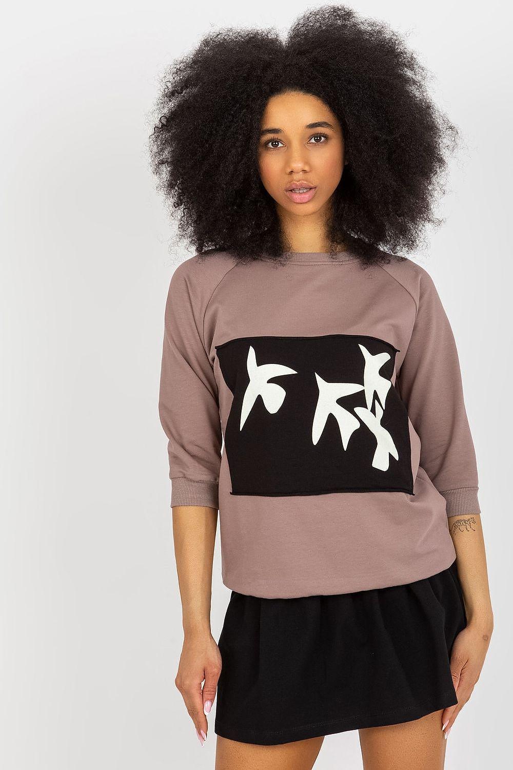 Brown sweatshirt with black art graphic and black high-waist skirt
